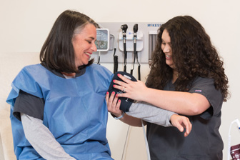 nurse takes patients blood pressure